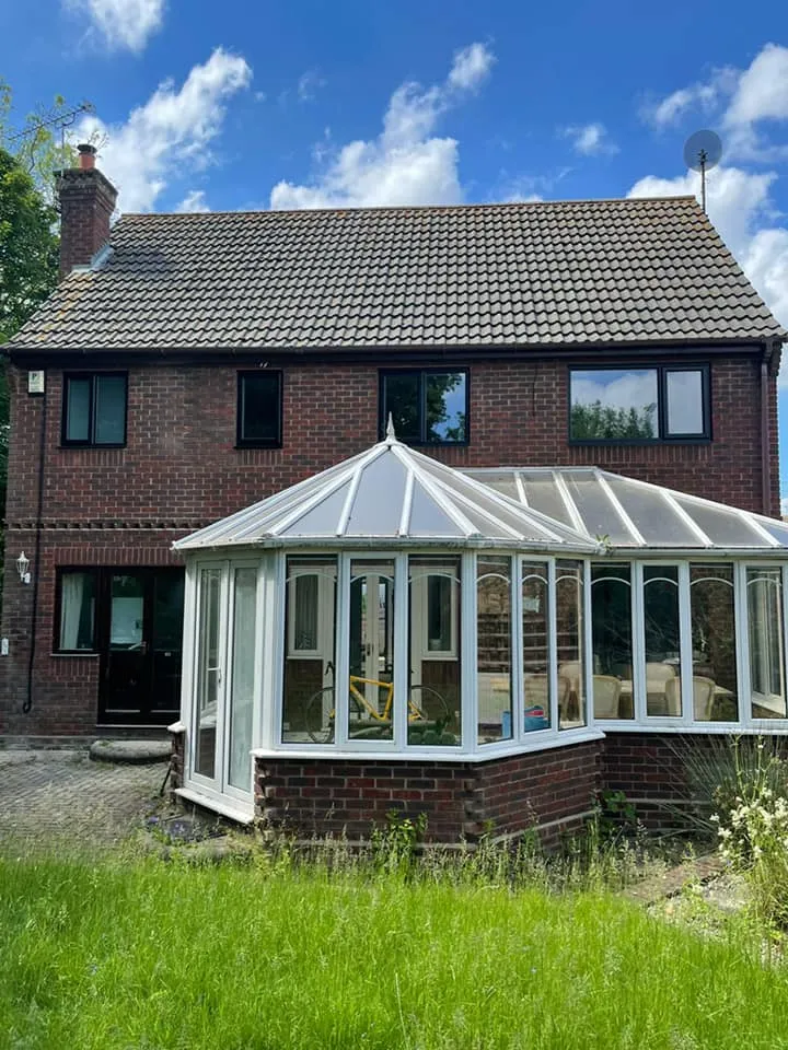 white conservatory on front of house