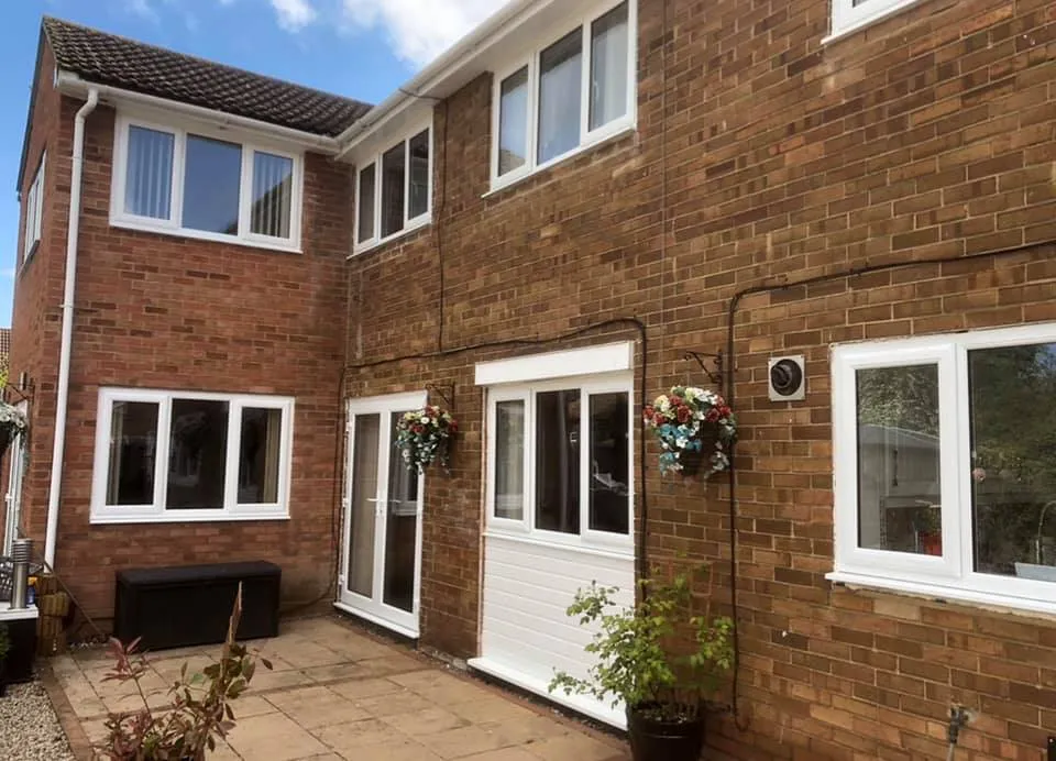 house with side extension white door and windows