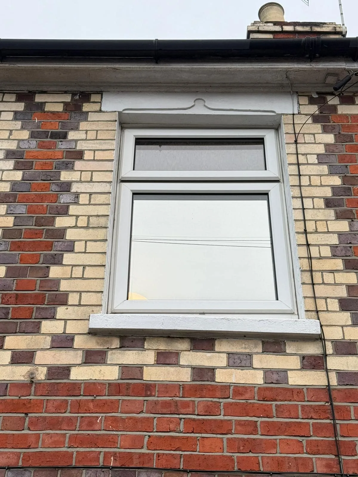 white window in patterned brickwork