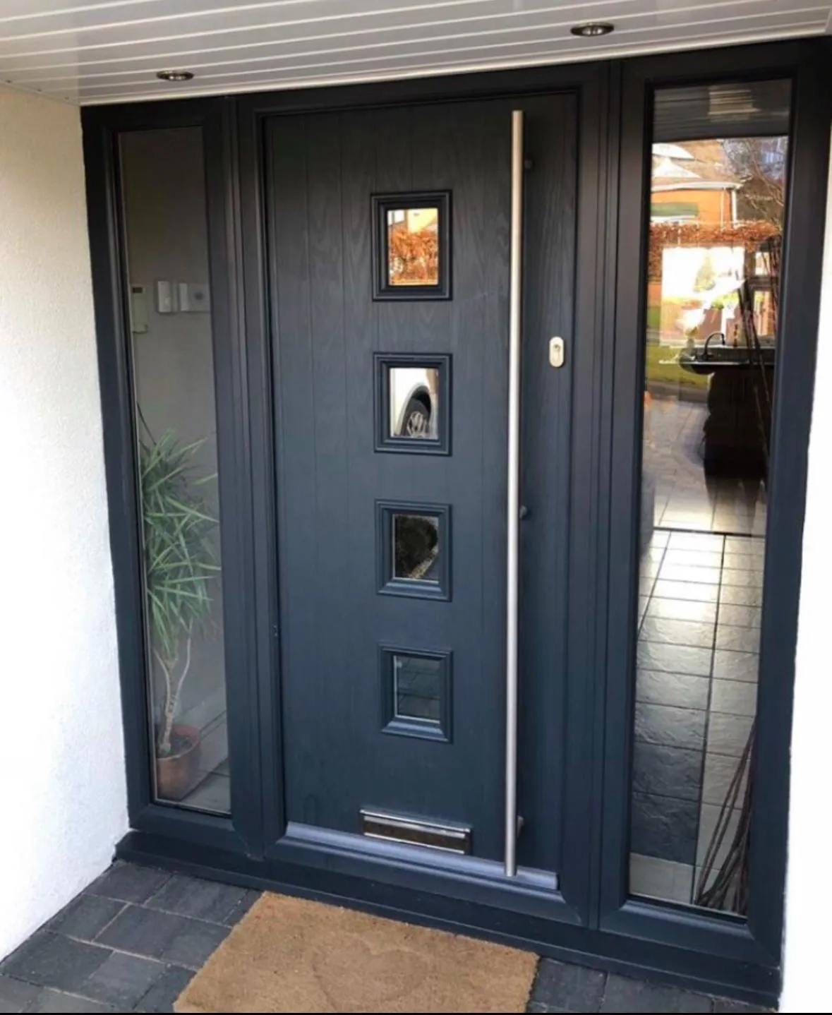 grey composite door on white house