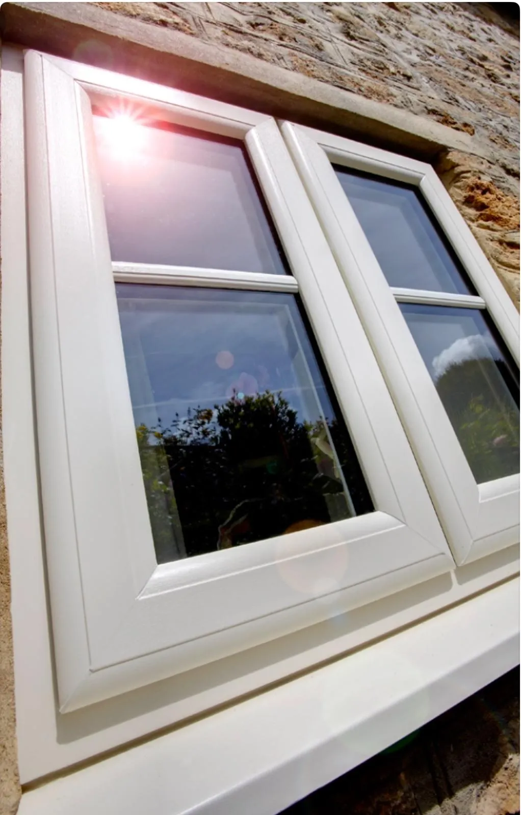 white windows with reflection of the sun